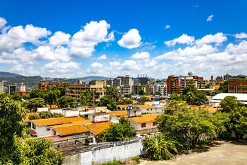Colorful city buildings of Caracas under the blue sky with clouds