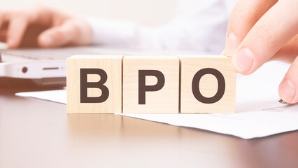 hand holding wooden cube with BPO text on table background. financial, marketing and business concepts