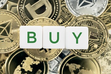 Buy word on cube blocks on crypto coins background