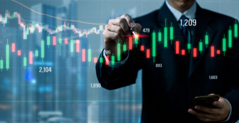 Businessman analysis graph stock market and financial , investment strategy and data report growth.