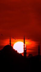 Suleymaniye Mosque and sun at sunset. Islamic or ramadan vertical photo.