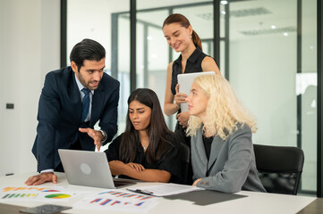 Group of coworkers in formal wear sitting at table in conference room. Business meeting team in office