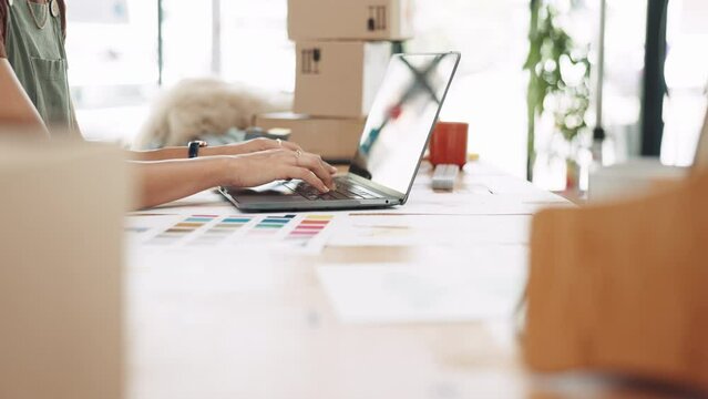 Woman, hands and laptop in fashion small business typing for online marketing, advertising or design at office desk. Hand of female clothing designer working on computer in logistics at workshop