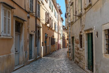 Aerial view of narrow street surrounded by old stony buildings in Rovinj