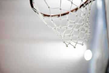 basketball hoop in the gym. Slow motion of a basketball hoop during a workout. basketball hoop, indoor sports arena. basketball hoop, close up - obrazy, fototapety, plakaty