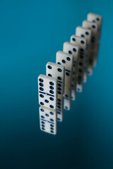board logic game for the whole family and friends of dominoes. light-colored dominoes with black dots on a light and mirror background