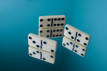 board logic game for the whole family and friends of dominoes. light-colored dominoes with black dots on a light and mirror background