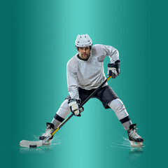 Professional ice hockey player hitting puck for winning goal in action on gradient multicolored...