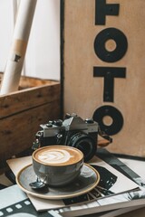 Closeup of a cup of latte with an art pattern on a table in a photo studio
