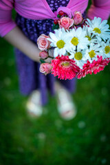 Young asian girl holding bouquet of flowers in spring