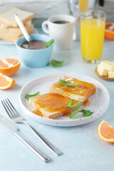 Sandwiches with marmalade, orange juice and coffee ready for breakfast