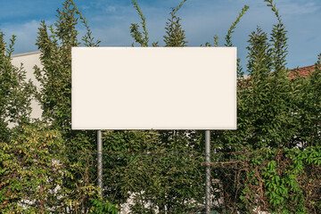 Blank white billboard on metal poles mounted on town street outdoor. Information sign board with mockup place. - Powered by Adobe