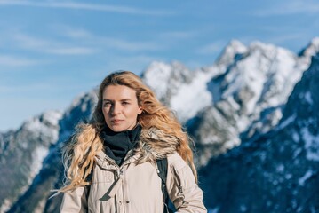Fototapeta na wymiar Female standing in front of snow covered mountain