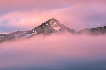 Fototapeta na wymiar Sunset in Iceland, Mountains and fog in colorful sunset, magic evening, East Iceland, Travel in Iceland