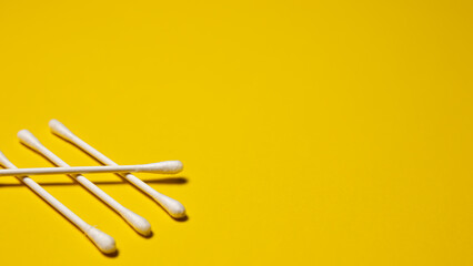 Cottons swab on a yellow background. Close-up.