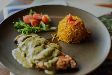 Close-up of a dinner served on a brown plate - restaurant dish concept