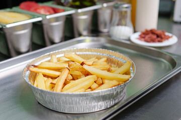 preparation of a vegan salchipapa in the kitchen, food
