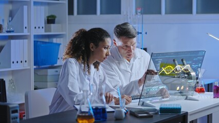 Medical scientists working in laboratory, conducting DNA research using advanced equipment