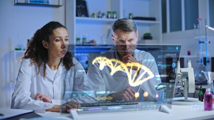 DNA scientists looking at DNA sequence on screen, puzzled with experiment results