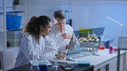 Unhappy lab scientists looking at dna structure on screen, experiment failure
