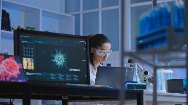 Bacteriology lab scientist working on research, using modern computer technology