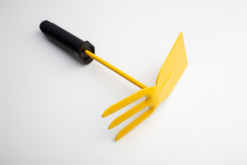 manual cultivator tool on a white background
