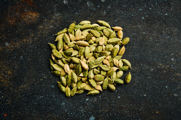Spicy cardamom seeds. Spices and condiments. Top view. On an old background.