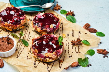 Dessert, pastry and a cup of coffee. Cherry brownie with cherry jam. On a gray stone background. Top view.