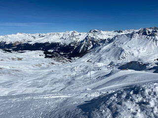 Snowy mountains in Switzerland. Panoramic view over the mountains during winter. Ski area Arosa, Lenzerheide in Switzerland. 