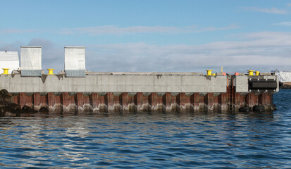 Mooring wall made of concrete and steel. Industrial background