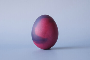 Colored Easter egg on a light blue background