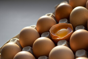 one broken egg against the background of whole eggs.