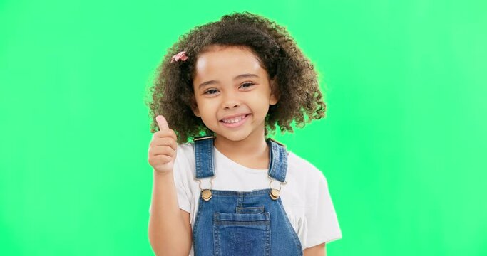 Happy, green screen and face of a child with a thumbs up isolated on a studio background. Winning, success and portrait of a girl kid with an emoji hand gesture for motivation, yes and agreement