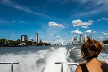 Sheer curtains Erasmus Bridge wake from Rotterdam Netherlands watertaxi vessel in high speed journey with female passenger. fast public transportation boat taxi service on water around Dutch city on sunny summer day in Holland