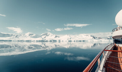Panorama from Cruise Ship showing Snow Glacier Covered Mountains Reflecting in the Still Arctic Water of Antarctica