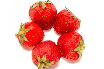 Five fresh ripe strawberries on a white background. Dessert. Beautiful and tasty strawberries. Close-up