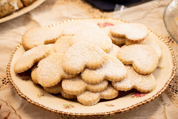 Heart Shaped Sugar Cookies on Old Fashioned Porcelain Plate Dusted in Sugar