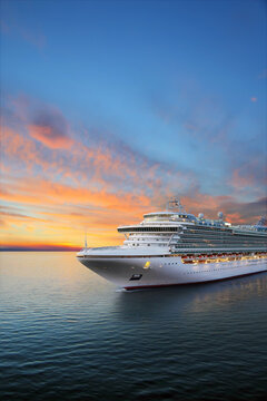 Luxury cruise ship sailing to port on sunrise 