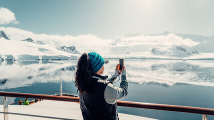 Female Tourist On Luxury Antarctica Cruise Ship Looking Out At The Stunning Scenic Arctic...