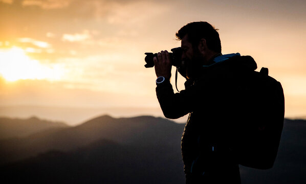 male photographer in nature at sunset