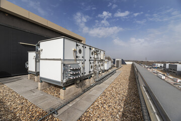 Equipment with filters and air conditioners on the roof of an industrial warehouse with floors full of gravel