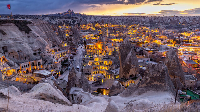 Goreme City at twilight, Famous tourist center of balloon fligths in Cappadocia, Turkiye, Aerial view twilight Goreme City from the mountain, Night view of Goreme, Cappadocia, Turkey.