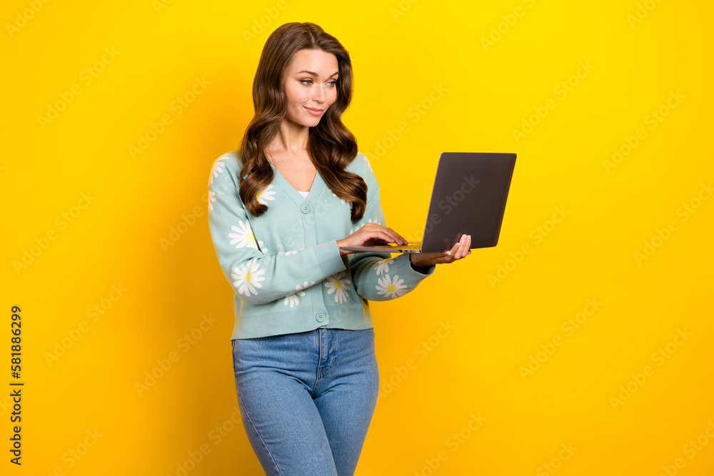 Poster portrait of gorgeous person hold use netbook communicate texting isolated on yellow color background