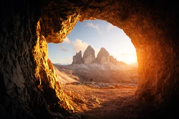 Fotobehang View from the cave in mountain against Three peaks of Lavaredo during sunset. Dolomite Alps, Italy. Landscape photography © Ivan Kmit