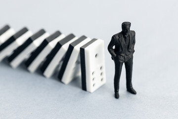 Domino effect concept. Dominoes falling and putting a company or investor at risk