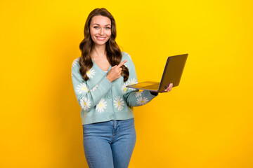 Creative photo advert of young satisfied student lady hold her new netbook direct finger new samsung gadget isolated on yellow color background
