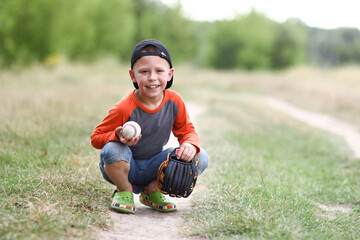 A Happy child with baseball ball on nature concept in park