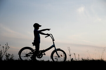 Fototapeta na wymiar silhouette Happy child and bike concept silhouette