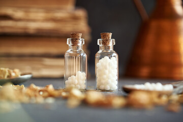 Obraz na płótnie Canvas Two bottles of homeopathic pills or globules