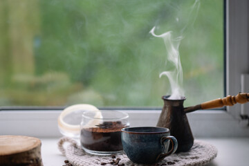 A cup of Turkish coffee on a spring window, green background.